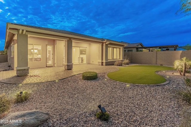 31207 N 124th Dr, Peoria, AZ 85383 - back of property with stucco siding, a fenced backyard, and a patio