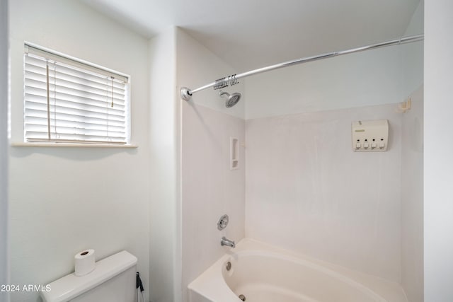 bathroom featuring shower / washtub combination and toilet