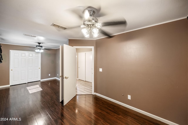 unfurnished room featuring ceiling fan, crown molding, and dark hardwood / wood-style flooring