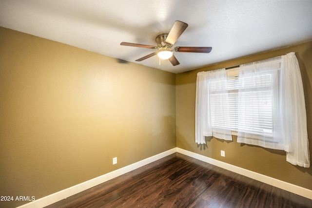 spare room featuring ceiling fan and dark hardwood / wood-style flooring