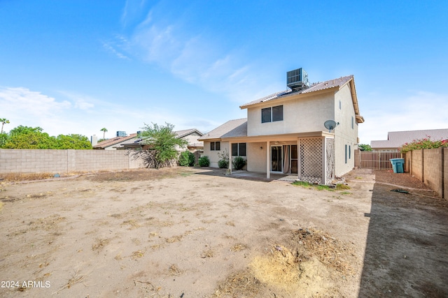 rear view of property featuring central AC and a patio area