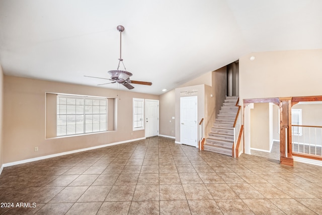 unfurnished living room featuring ceiling fan, vaulted ceiling, and light tile patterned floors