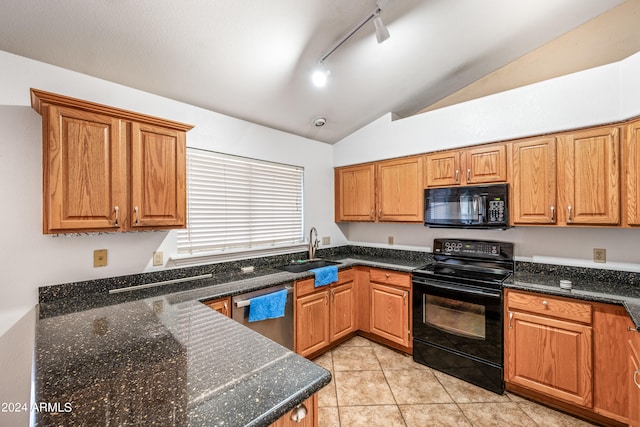 kitchen with lofted ceiling, black appliances, rail lighting, sink, and light tile patterned floors