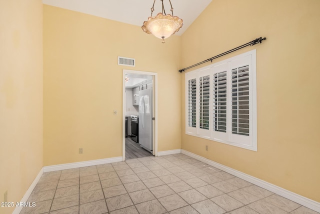 1549 N La Rosa Dr, Tempe, AZ 85288 - unfurnished room featuring baseboards and a towering ceiling