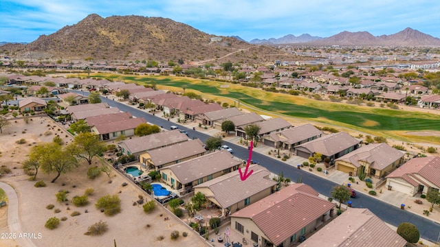 drone / aerial view featuring a residential view, view of golf course, and a mountain view