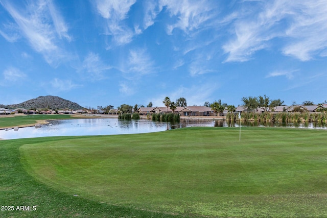 surrounding community featuring a water view, a lawn, and golf course view