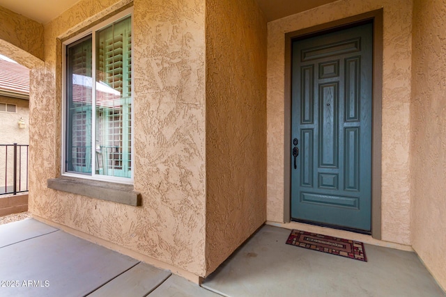 entrance to property with stucco siding