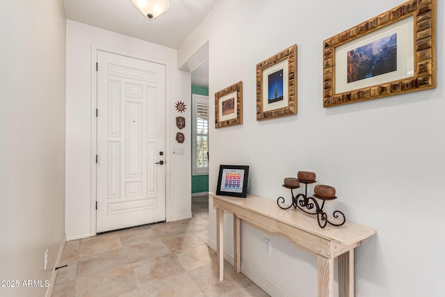 entryway featuring light tile patterned floors and baseboards