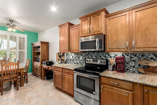 kitchen with stainless steel appliances, brown cabinetry, and tasteful backsplash