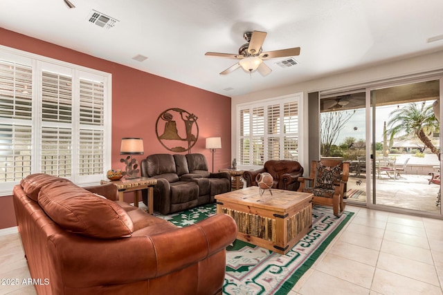 living room featuring light tile patterned floors, ceiling fan, and visible vents