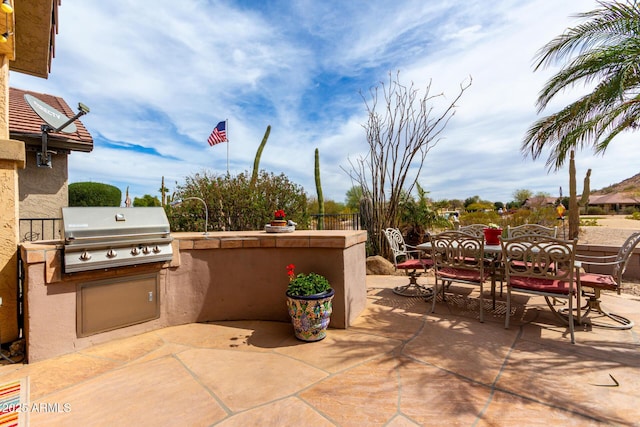 view of patio / terrace featuring outdoor dining area, grilling area, and area for grilling