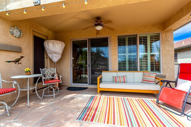 view of patio with an outdoor living space and a ceiling fan