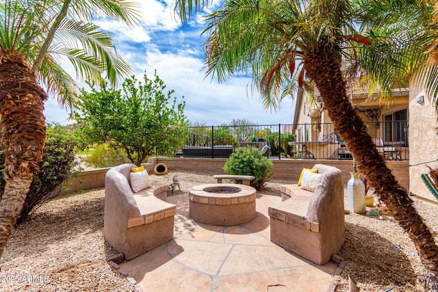 view of patio / terrace with an outdoor fire pit and fence