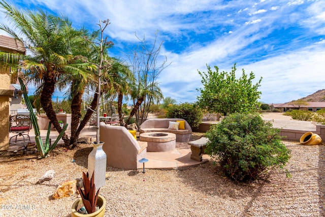 view of yard with a patio and an outdoor fire pit