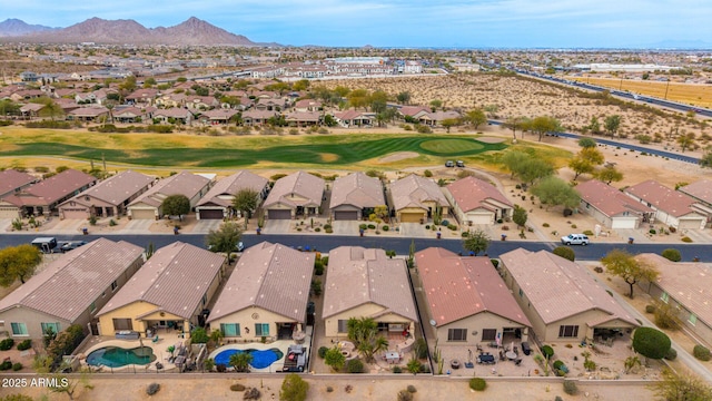 aerial view with a mountain view, golf course view, and a residential view