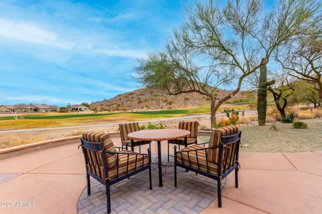 view of patio with a mountain view and outdoor dining area