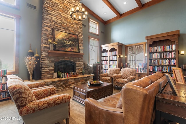 living room with a high ceiling, a fireplace, visible vents, and beamed ceiling