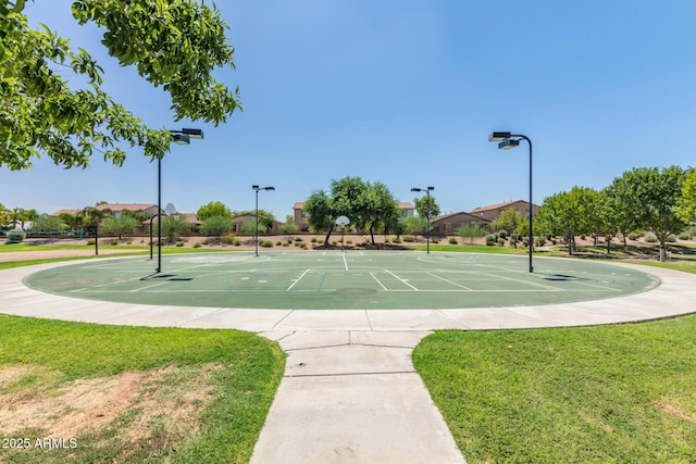 view of community featuring community basketball court and a lawn