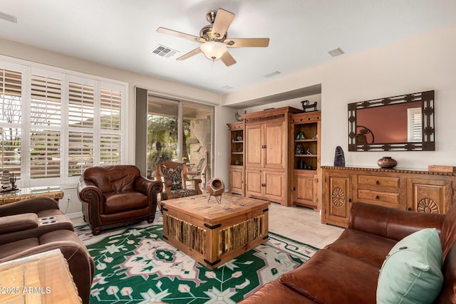 living room with visible vents and a ceiling fan