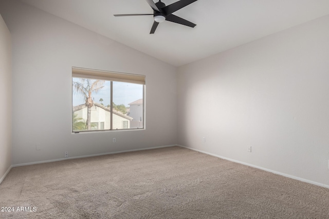 carpeted spare room with ceiling fan and vaulted ceiling