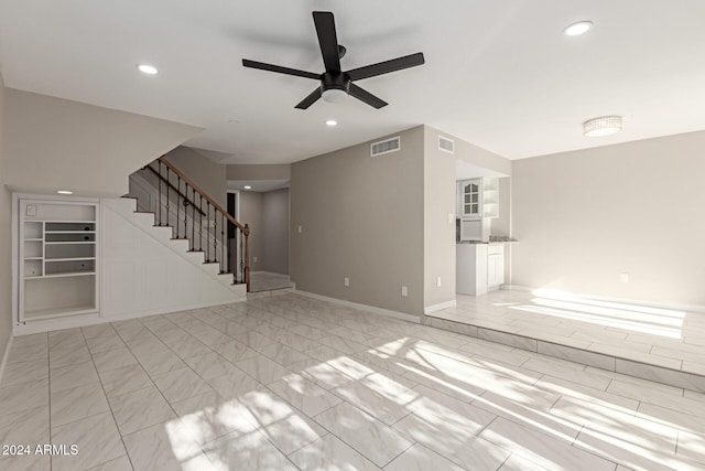 unfurnished living room with ceiling fan