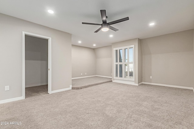 interior space featuring light colored carpet and ceiling fan