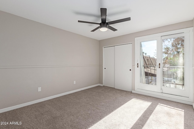 unfurnished bedroom featuring carpet flooring, ceiling fan, and a closet