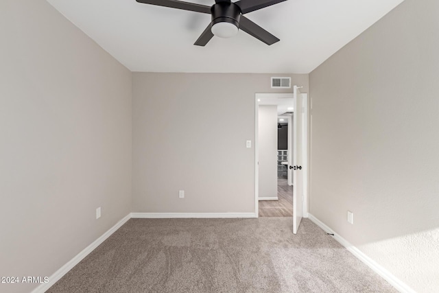 carpeted empty room with ceiling fan