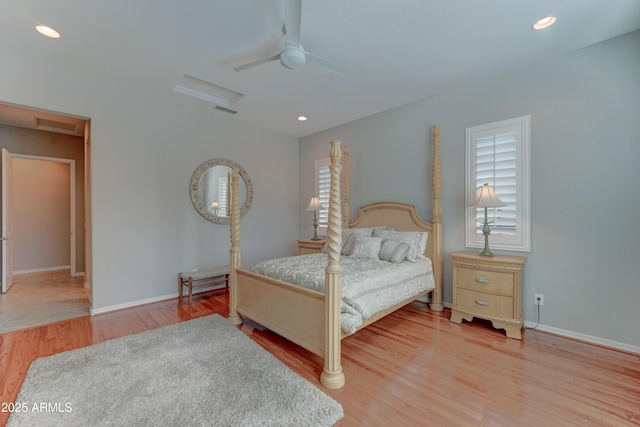 bedroom with light wood finished floors, attic access, visible vents, baseboards, and recessed lighting