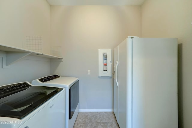 washroom with baseboards, laundry area, and washer and dryer