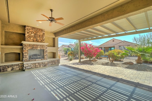 view of patio featuring fence and an outdoor stone fireplace