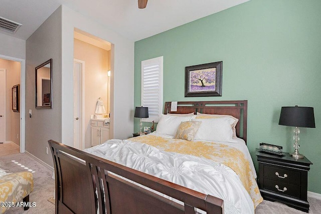 carpeted bedroom featuring ensuite bathroom and ceiling fan