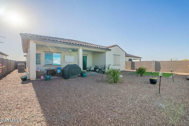 rear view of house featuring central AC unit and a patio