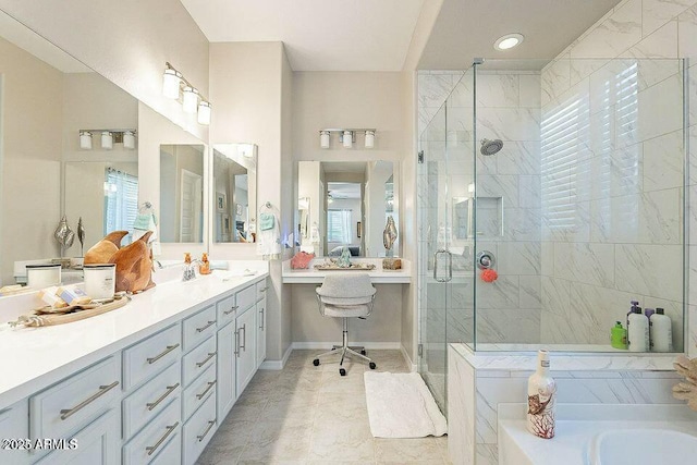 bathroom with vanity and shower with separate bathtub