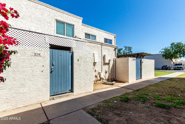 property entrance with stucco siding