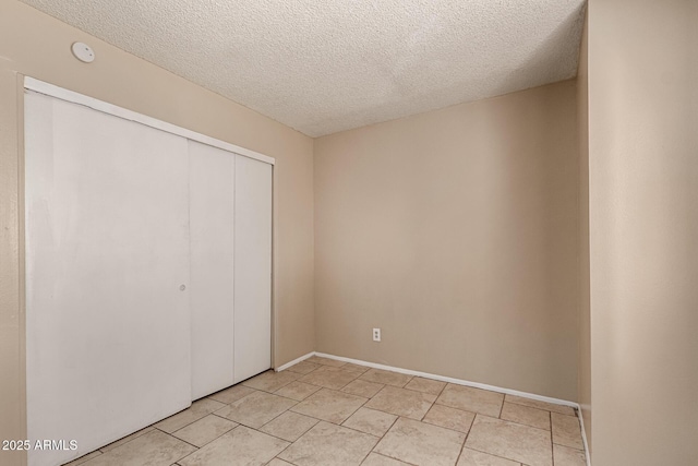 unfurnished bedroom with a closet and a textured ceiling