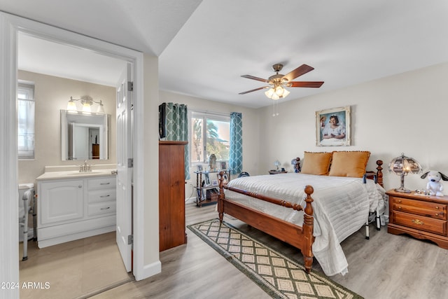 bedroom featuring connected bathroom, ceiling fan, light hardwood / wood-style flooring, and sink