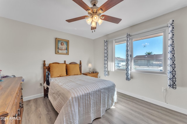 bedroom with ceiling fan and hardwood / wood-style floors