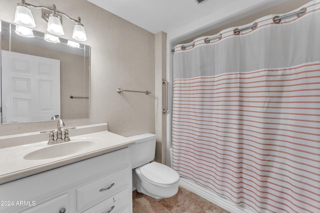 bathroom featuring tile patterned flooring, vanity, and toilet