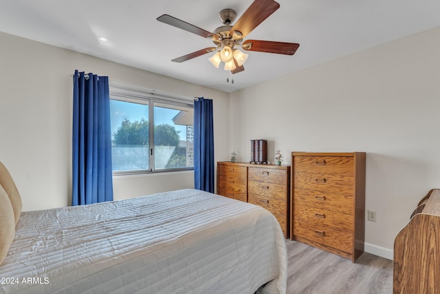 bedroom with ceiling fan and light hardwood / wood-style floors