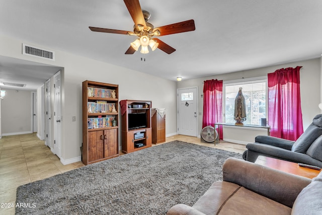 living room with ceiling fan and light tile patterned flooring