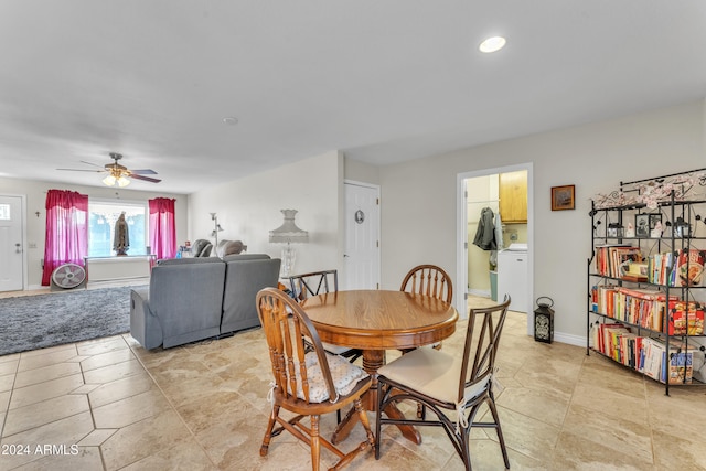 dining space featuring ceiling fan and washer / dryer