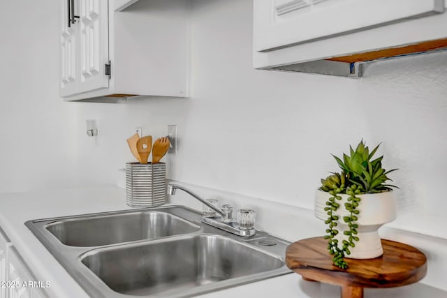 kitchen featuring white cabinetry and sink