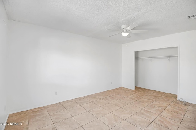 unfurnished bedroom featuring a textured ceiling, a closet, and ceiling fan