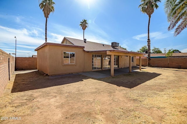 rear view of property with central AC unit