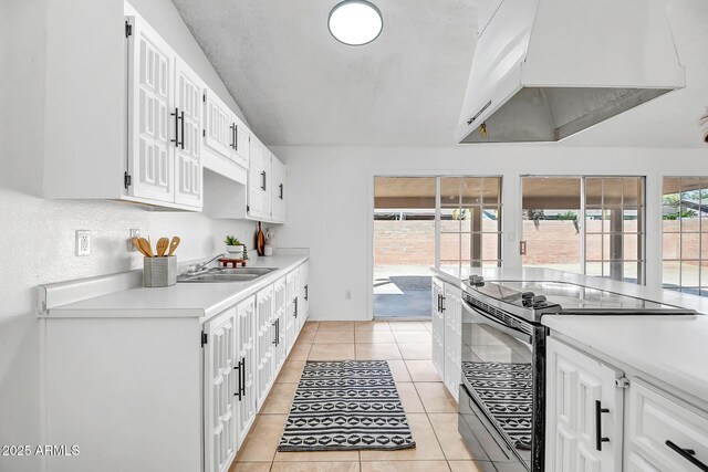 kitchen with white cabinets, sink, electric range, and range hood