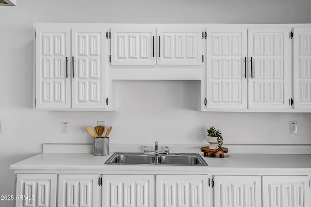 kitchen with white cabinetry and sink