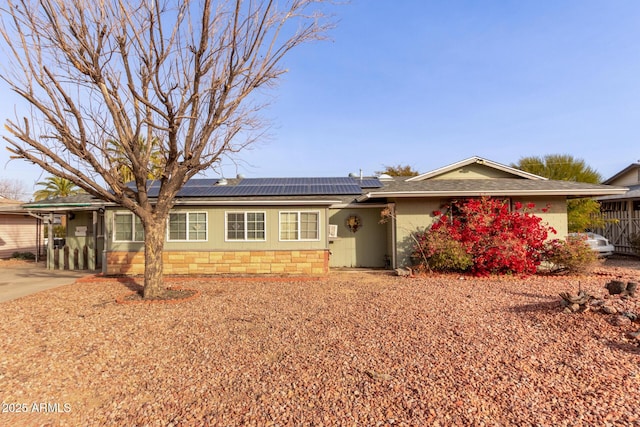 single story home with solar panels