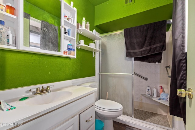 bathroom with vanity, toilet, and an enclosed shower