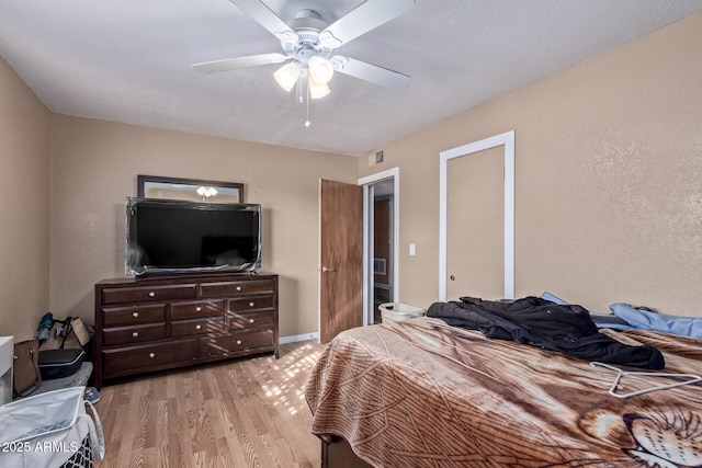 bedroom with ceiling fan and light hardwood / wood-style floors